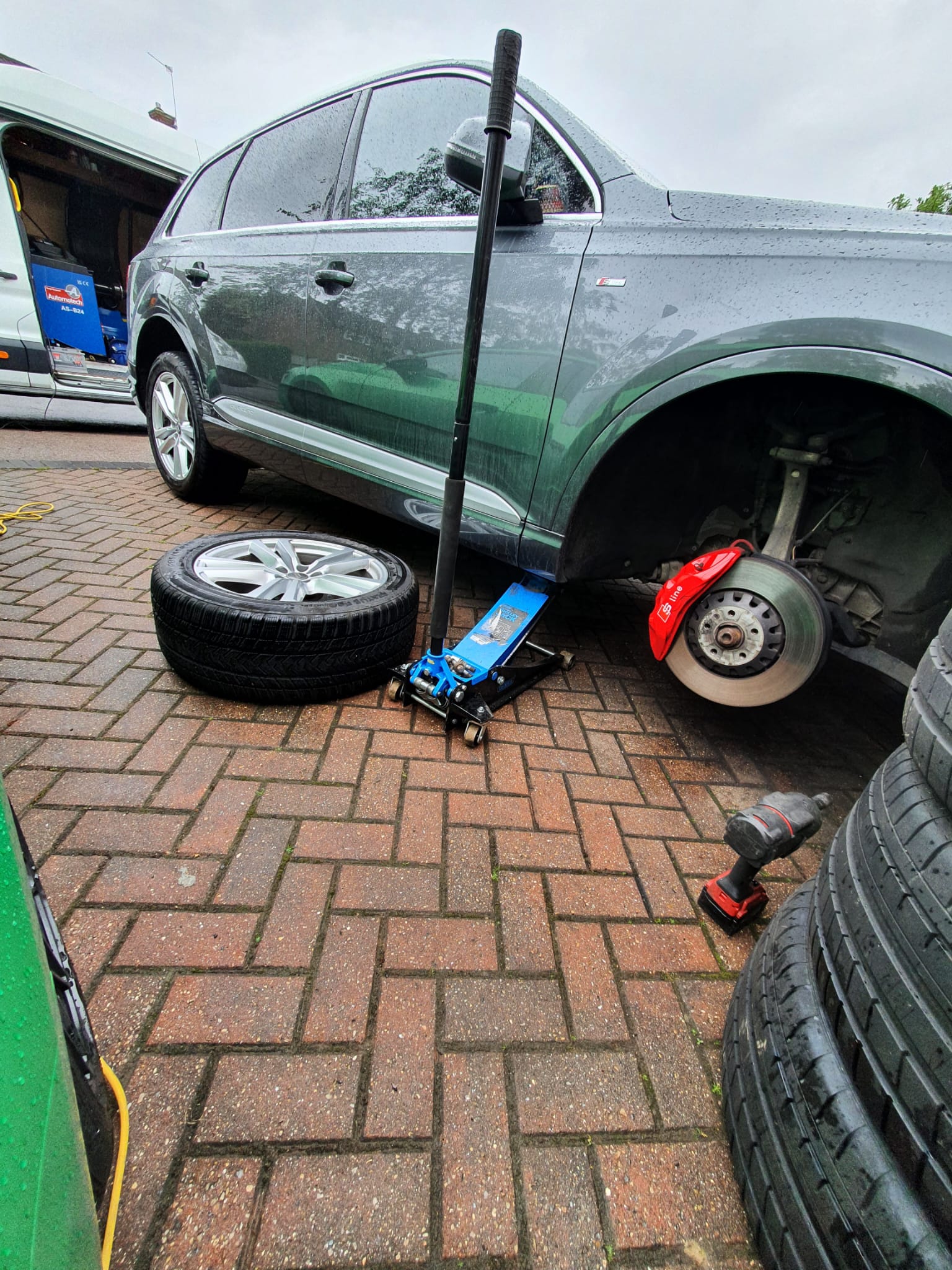 a car with a jack on the ground