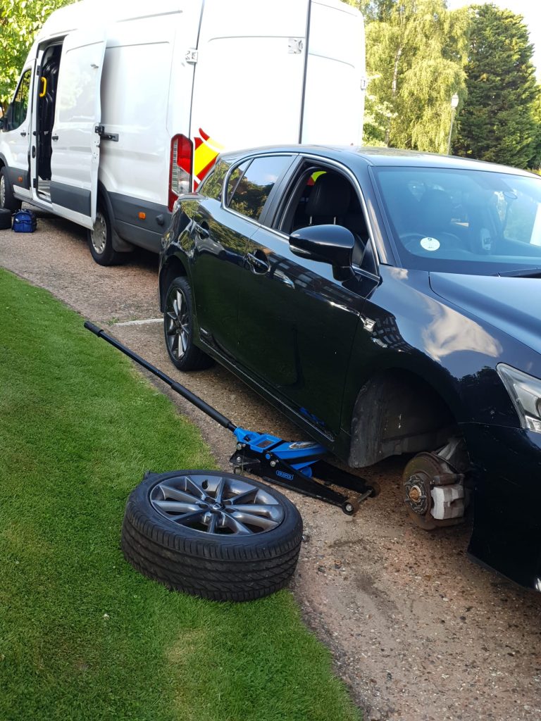 a car with a jack on the ground