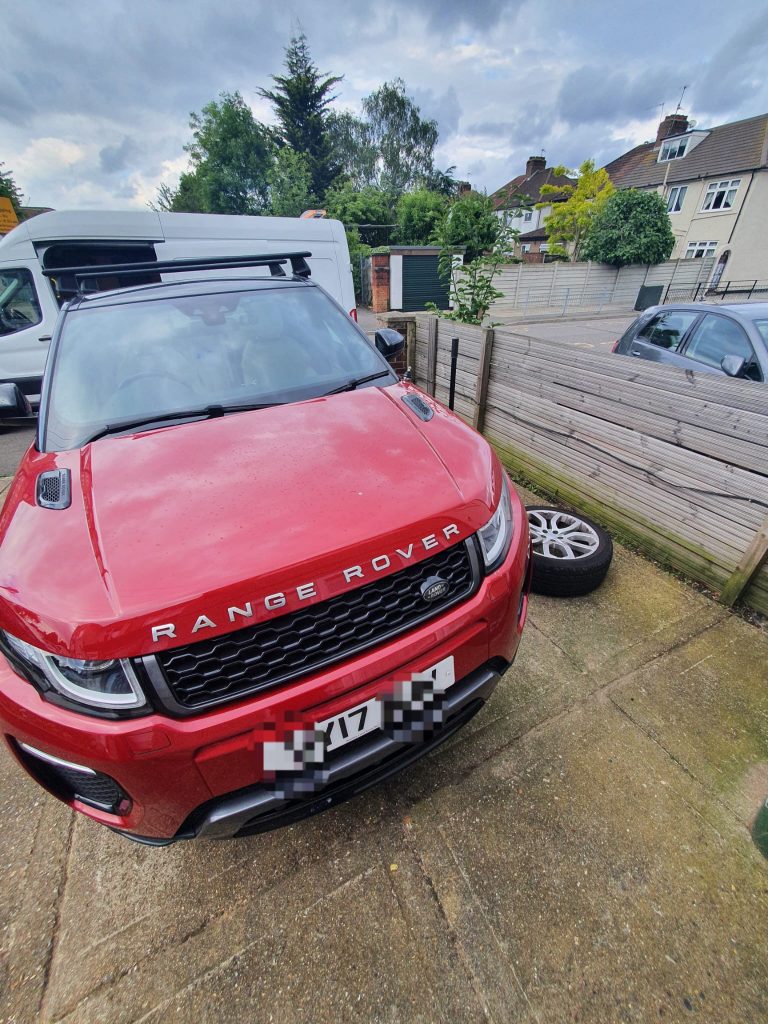 a red car parked in a driveway