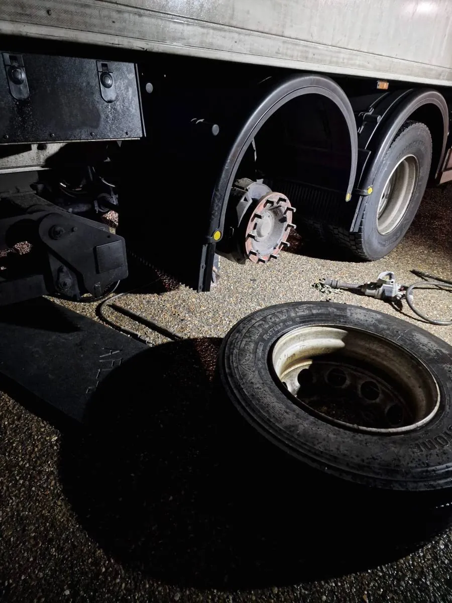 HGV with a rear wheel removed during a roadside tyre change