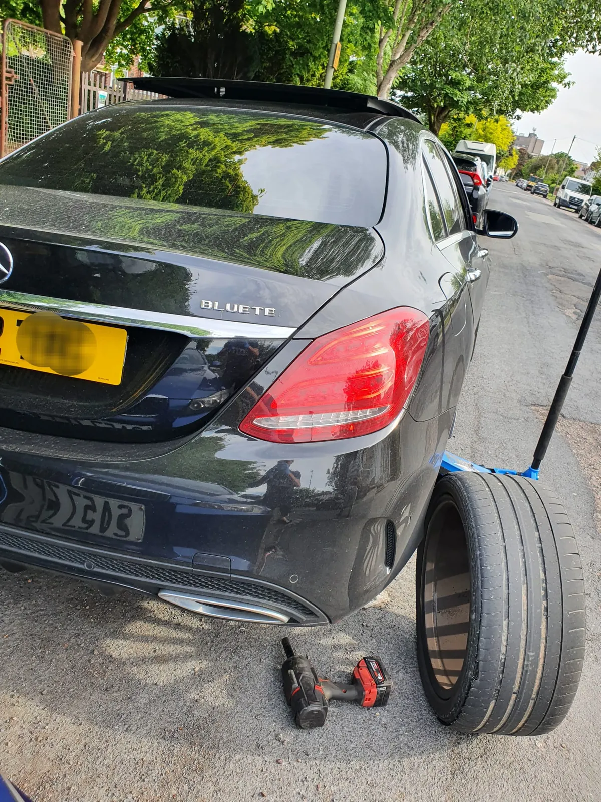 Mercedes C-Class at the kerb with a new tyre ready to fit